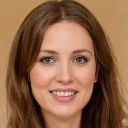 Joyful white young-adult female with long  brown hair and green eyes