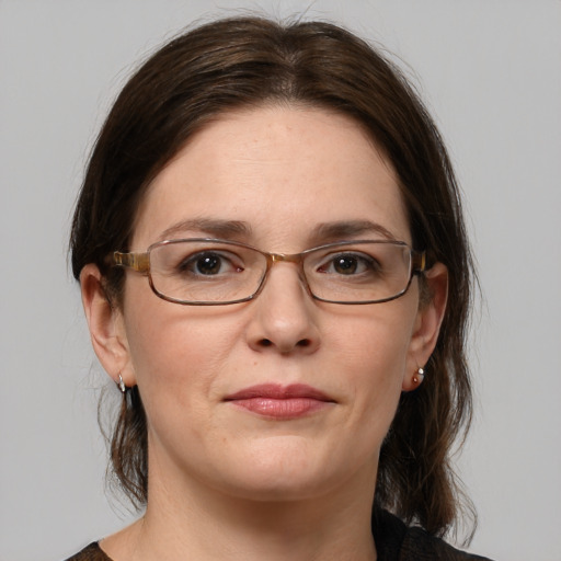 Joyful white adult female with medium  brown hair and grey eyes