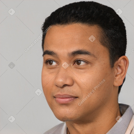 Joyful black young-adult male with short  black hair and brown eyes