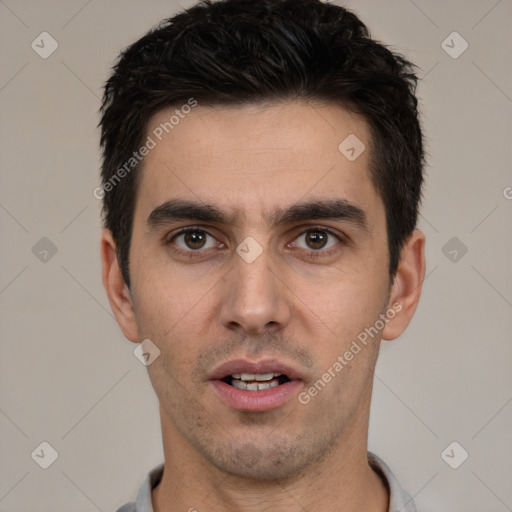 Joyful white young-adult male with short  black hair and brown eyes