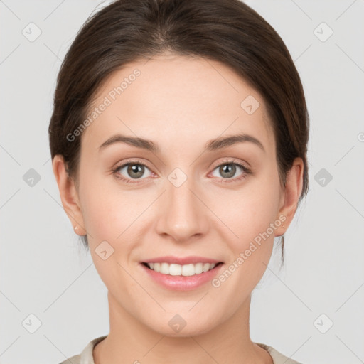 Joyful white young-adult female with medium  brown hair and grey eyes