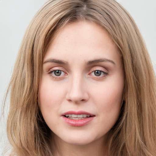 Joyful white young-adult female with long  brown hair and green eyes