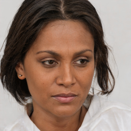 Joyful white adult female with medium  brown hair and brown eyes