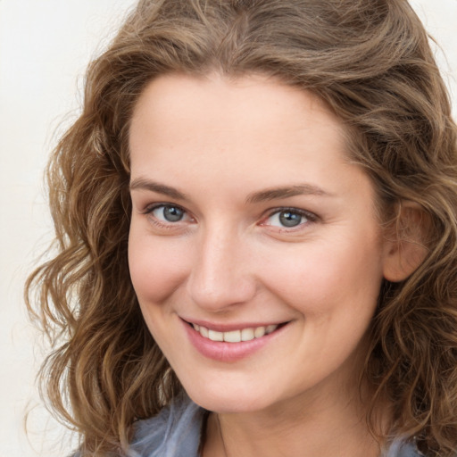 Joyful white young-adult female with medium  brown hair and green eyes