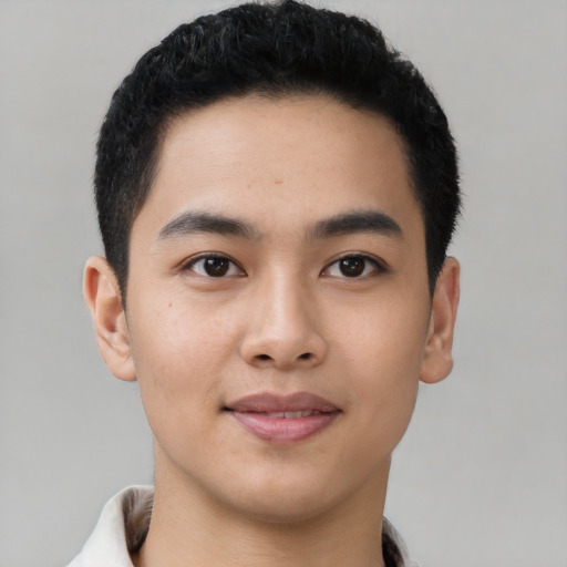 Joyful asian young-adult male with short  black hair and brown eyes