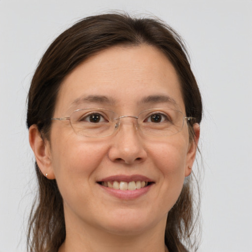 Joyful white adult female with medium  brown hair and brown eyes