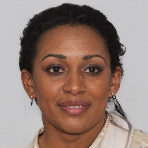 Joyful black adult female with short  brown hair and brown eyes