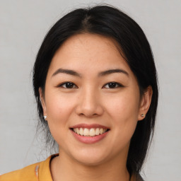 Joyful asian young-adult female with medium  black hair and brown eyes