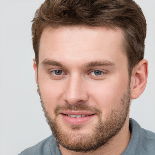 Joyful white young-adult male with short  brown hair and brown eyes