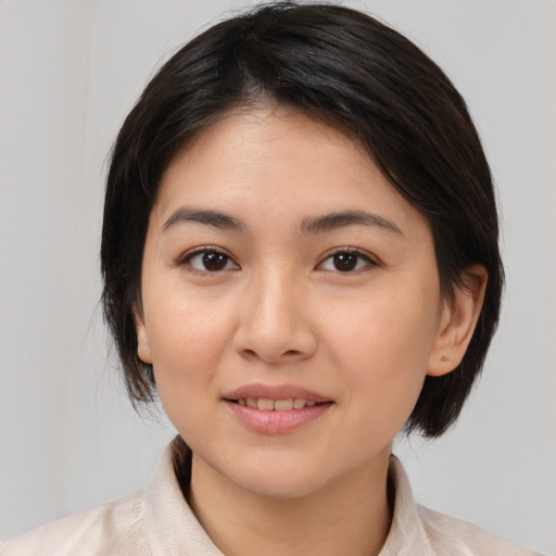 Joyful asian young-adult female with medium  brown hair and brown eyes
