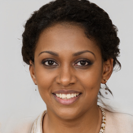 Joyful black young-adult female with long  brown hair and brown eyes