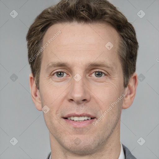 Joyful white adult male with short  brown hair and grey eyes