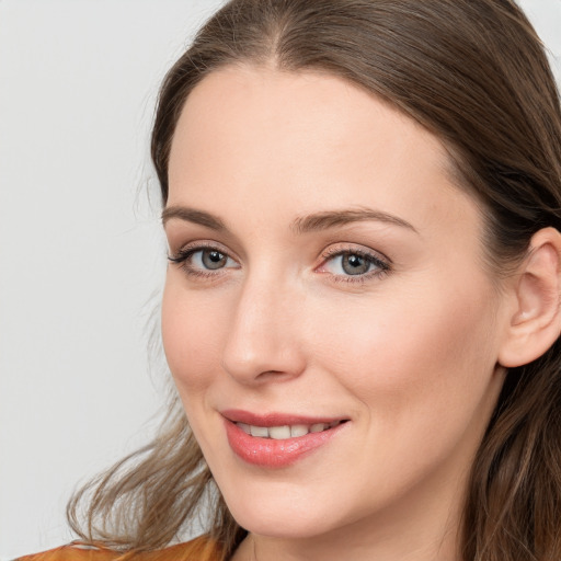 Joyful white young-adult female with long  brown hair and blue eyes