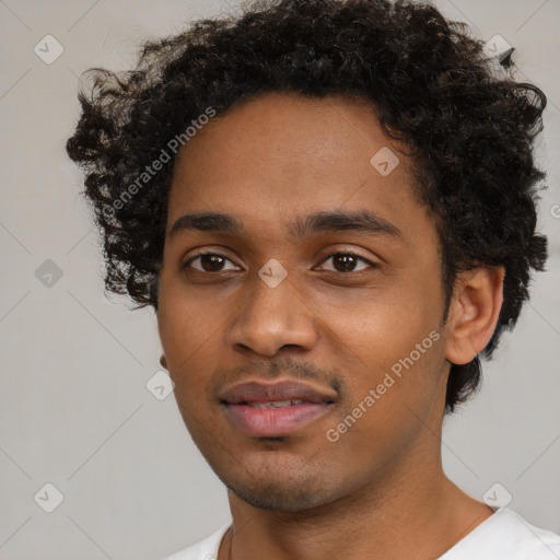 Joyful black young-adult male with short  brown hair and brown eyes