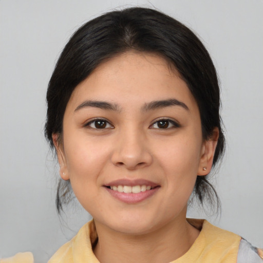 Joyful latino young-adult female with medium  brown hair and brown eyes