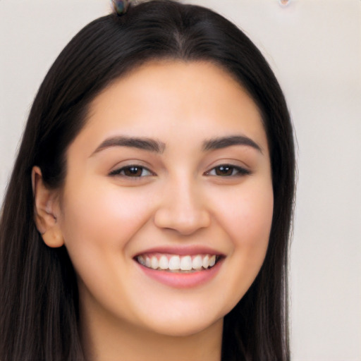 Joyful latino young-adult female with long  brown hair and brown eyes