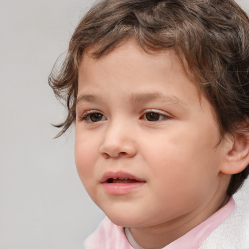 Joyful white child male with medium  brown hair and brown eyes