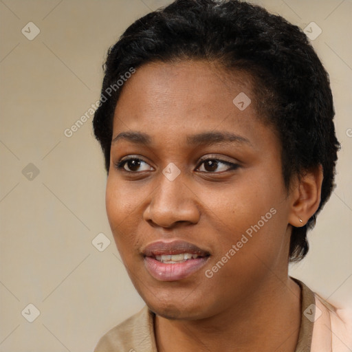 Joyful black young-adult female with short  black hair and brown eyes