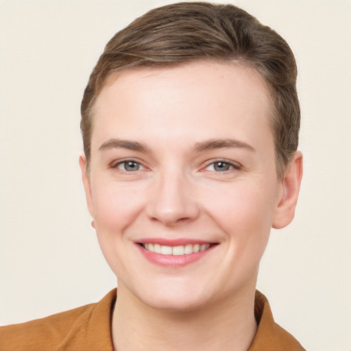 Joyful white young-adult female with short  brown hair and grey eyes