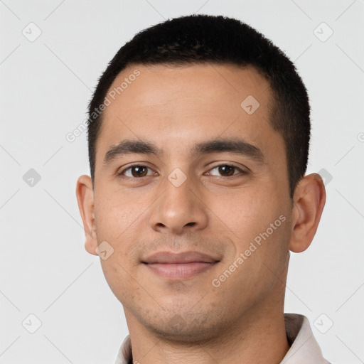 Joyful latino young-adult male with short  black hair and brown eyes