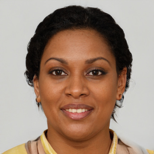 Joyful black young-adult female with short  brown hair and brown eyes