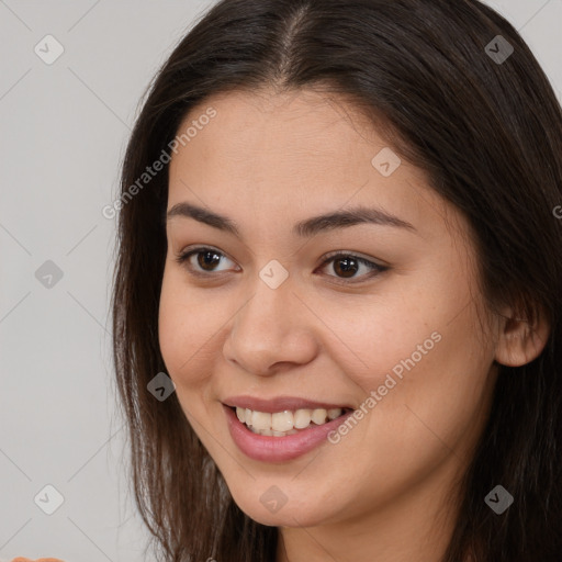 Joyful white young-adult female with long  brown hair and brown eyes