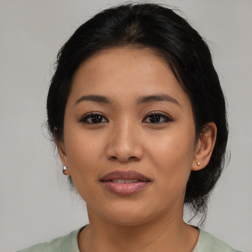 Joyful latino young-adult female with medium  black hair and brown eyes