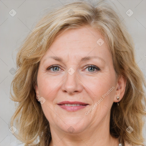 Joyful white adult female with medium  brown hair and blue eyes