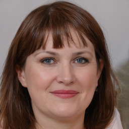 Joyful white adult female with medium  brown hair and brown eyes