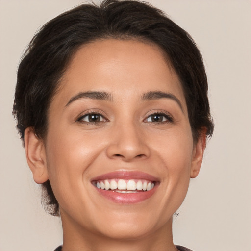 Joyful white young-adult female with short  brown hair and brown eyes