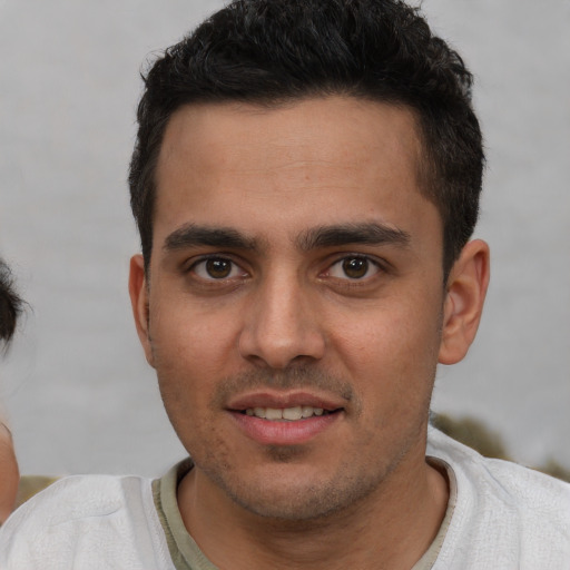 Joyful white young-adult male with short  brown hair and brown eyes