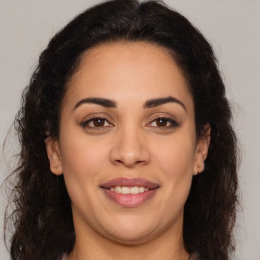 Joyful latino young-adult female with long  brown hair and brown eyes