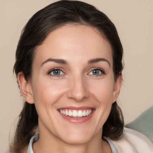 Joyful white young-adult female with medium  brown hair and brown eyes