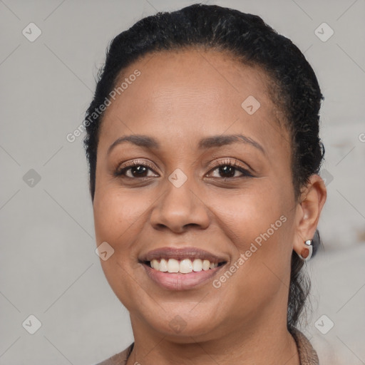 Joyful black young-adult female with short  brown hair and brown eyes