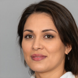 Joyful white adult female with medium  brown hair and brown eyes