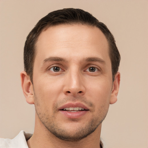 Joyful white young-adult male with short  brown hair and brown eyes