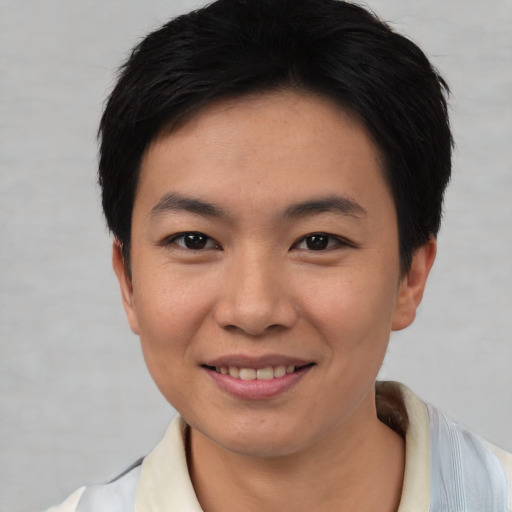 Joyful asian young-adult female with short  black hair and brown eyes