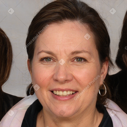 Joyful white adult female with medium  brown hair and blue eyes