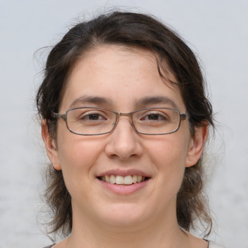 Joyful white adult female with medium  brown hair and brown eyes