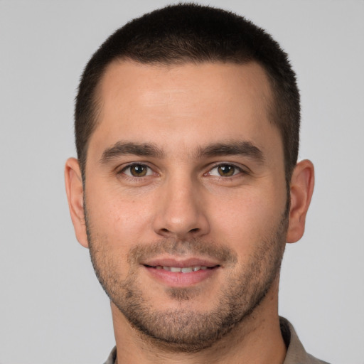 Joyful white young-adult male with short  brown hair and brown eyes