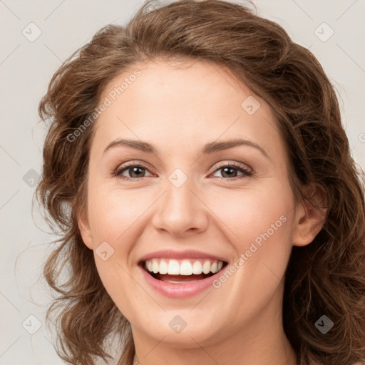 Joyful white young-adult female with long  brown hair and green eyes