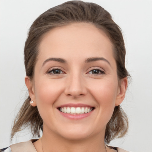 Joyful white young-adult female with medium  brown hair and grey eyes