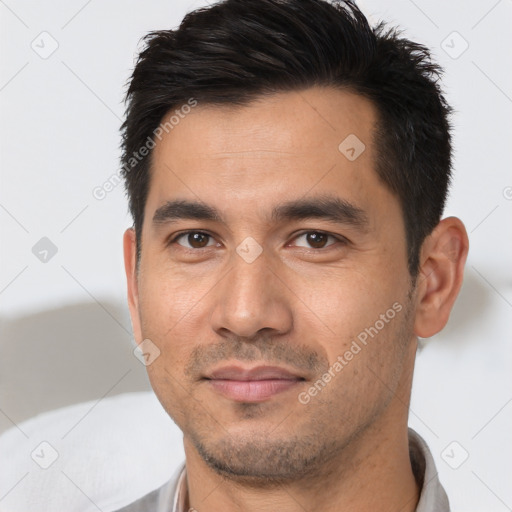 Joyful asian young-adult male with short  black hair and brown eyes