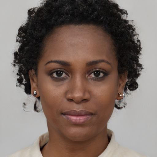 Joyful black young-adult female with short  brown hair and brown eyes