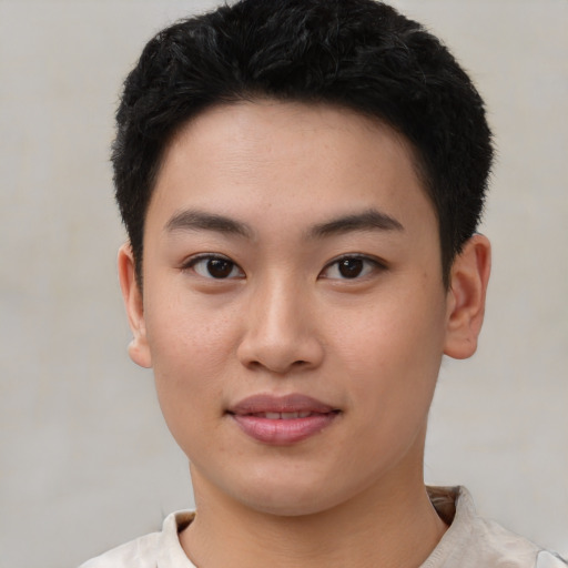 Joyful asian young-adult male with short  brown hair and brown eyes