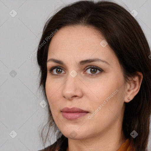 Joyful white adult female with long  brown hair and brown eyes