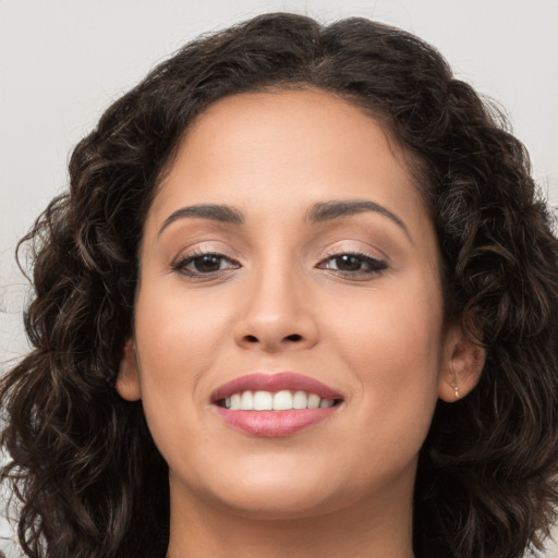 Joyful white young-adult female with long  brown hair and brown eyes