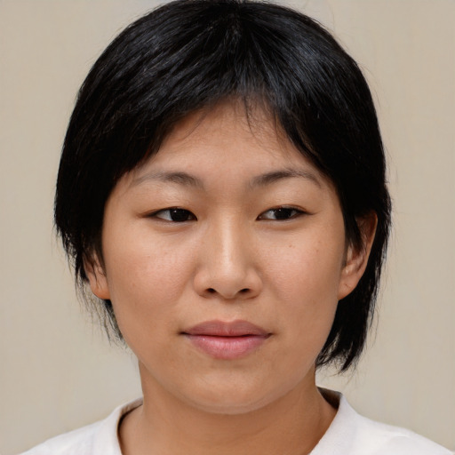 Joyful asian young-adult female with medium  black hair and brown eyes