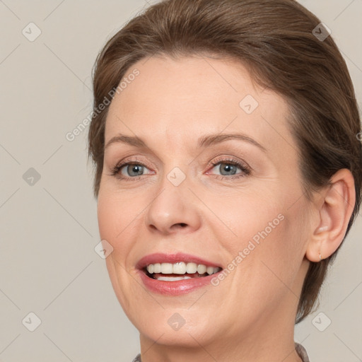 Joyful white adult female with medium  brown hair and grey eyes