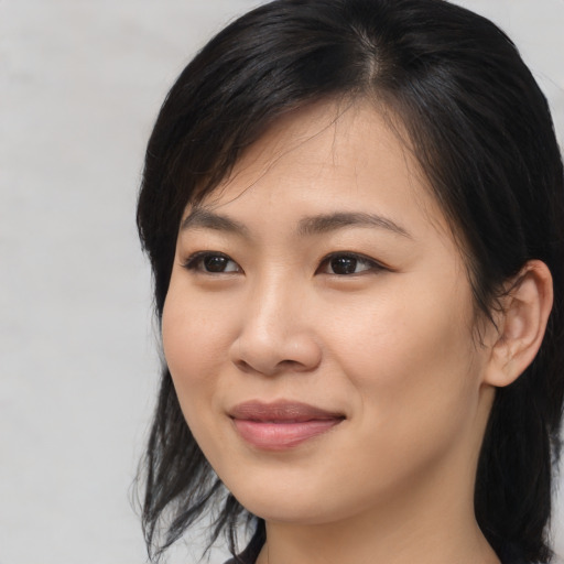 Joyful asian young-adult female with medium  black hair and brown eyes
